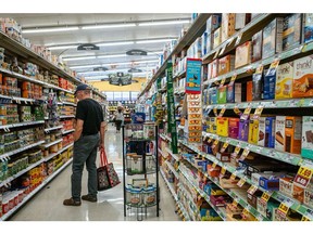 A customer shops in a grocery store in Houston, Texas. Photographer: Brandon Bell/Getty Images