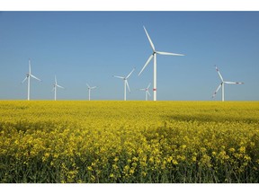 PINNOW, GERMANY - MAY 10: Wind turbines spin over a field of canola, also called rapeseed, at a wind park on May 10, 2023 near Pinnow, Germany. The German government is seeking a rapid expansion of Germany's renewable energy production capacity, with wind and photovoltaic as the favoured technologies.