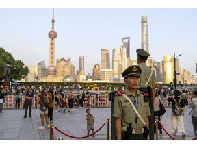 Paramilitary police officers stand guard near the Bund in Pudong's Lujiazui Financial District in Shanghai, China, on Monday, Sept. 18, 2023. China's central bank will strengthen efforts to stabilize trade and improve the business environment for foreign firms, its governor said Monday, adding to pledges among top leaders this year to open up to overseas investors. Photographer: Raul Ariano/Bloomberg