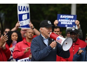 US President Joe Biden addresses striking members of the United Auto Workers (UAW) union at a picket line outside a General Motors Service Parts Operations plant in Belleville, Michigan, on September 26, 2023.  Photographer: Jim Watson/AFP/Getty Images