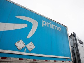 Signage is displayed on a truck outside of an Amazon delivery station.