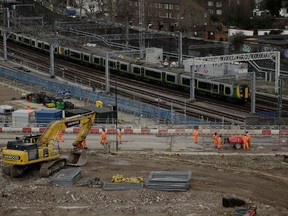 FILE - A train passes the construction site of the High Speed 2 (HS2) rail line at Euston station in London, Tuesday, Feb. 11, 2020. The British government confirmed Sunday, Sept. 24, 2023 it may scrap a big chunk of an overdue, over-budget high-speed rail line once touted as a key way to attract jobs and investment to northern England.