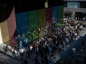 People line up to buy the newly launched iPhone 15 and other Apple products outside a flagship store on Sept. 22, 2023 in Beijing, China.