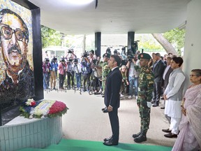 French President Emmanuel Macron pays homage to Bangladesh's independence leader Sheikh Mujibur Rahman at the Bangabandhu Memorial Museum in Dhaka, Bangladesh, Monday, Sept.11, 2023.