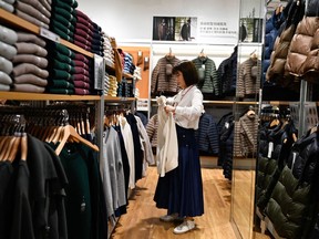 A shopper browses through clothing at a mall in Beijing.