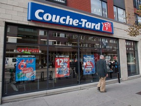 A man passes by a Couche Tard convenience store in Montreal.