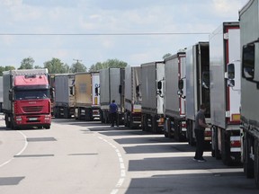 FILE - Trucks stands at the post-customs international checkpoint Chernyshevskoye at the Russian-Lithuanian border in Kaliningrad region, Russia, Wednesday, June 22, 2022. The Baltic states of Estonia, Latvia and Lithuania have in a jointly coordinated move banned vehicles with Russian license plates from entering their territory as part of the European Union's recent new interpretation of sanctions against Moscow. (AP Photo, File)