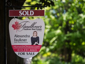 A sold sign in front of a home in Ontario.