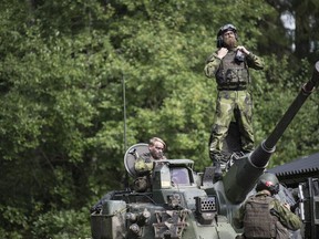 FILE - Swedish soldiers from Skaraborg's Swedish regiments take part in a training exercise as part of the preparations for Aurora 17 field exercise, in Skovde, Sweden, on Sept. 14, 2017. The Swedish government said Monday Sept. 11, 2023 it wants to increase its defense budget by 28%, putting it on track to reach the spending target 2% of gross domestic product set by the NATO alliance, which the Scandinavian country is preparing to join.