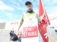 Striking Metro grocery store workers hold picket lines in Toronto in August.