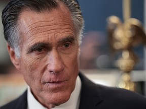 Sen. Mitt Romney answers questions in his office after announcing on Sept. 13 that he will not seek re-election.