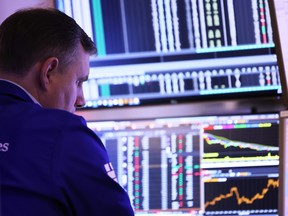 Traders work on the floor of the New York Stock Exchange.