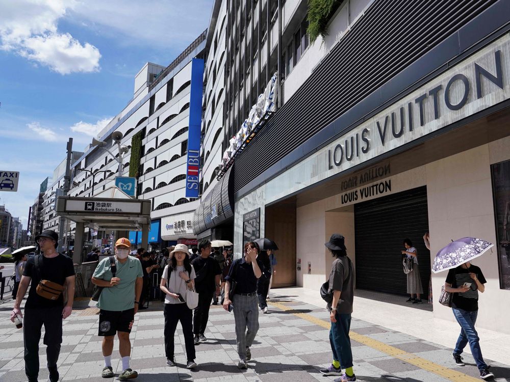 Pedestrians walk past a Louis Vuitton store, operated by LVMH Moet News  Photo - Getty Images