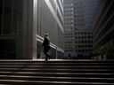 A commuter walks up stairs in the financial district of Toronto.