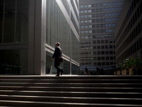 A commuter walks up stairs in the financial district of Toronto.