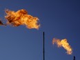 Flares burn off methane and other hydrocarbons at an oil and gas facility in Lenorah, Texas.