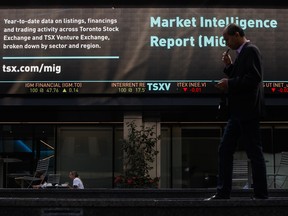 A pedestrian passes front of the Toronto Stock Exchange in the financial district of Toronto.