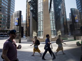 Pedestrians outside the Royal Bank of Canada head office in the financial district of Toronto.