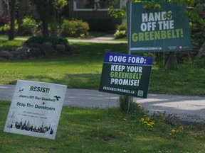 Signboards voicing opposition to the Ontario government's plans for the Greenbelt outside homes within the Duffins Rouge Agricultural Preserve.