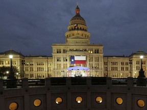 FILE - In this Jan. 14, 2019 file photo, a large Texas flag hangs from the Texas State Capitol in Austin, Texas. A federal judge has struck down a Texas law requiring age verification and health warnings to view pornographic websites and blocked the state attorney general's office from enforcing it. U.S. District Judge David Ezra on Thursday, Aug. 31, 2023 agreed with claims that the bill signed into law by Gov. Greg Abbott in June violates free speech rights, is overbroad and vague.