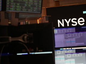 FILE - A screen displays the NYSE logo on the floor at the New York Stock Exchange in New York, Friday, June 2, 2023.