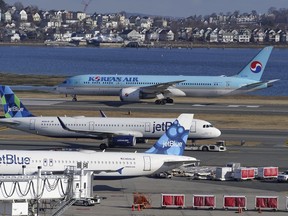 FILE - Passenger jets are seen on the tarmac at Logan International Airport, Jan. 11, 2023, in Boston. The Federal Aviation Administration is considering requiring that all planes be equipped with technology designed to prevent close calls around airports, Friday, Sept. 8.