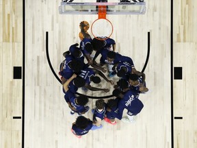 FILE - Saint Peter's players huddle before the second half of a college basketball game against Purdue in the Sweet 16 round of the NCAA tournament, Friday, March 25, 2022, in Philadelphia. The online sports betting company PointsBet committed three different types of violations of New Jersey sports betting laws, including taking bets on soccer games that had already ended, according to gambling regulators who fined the company $25,000. PointsBet accepted bets on March 25, 2022 on the St. Peter's men's basketball team, but which was ineligible to be bet on in New Jersey. The market for St. Peter's bets was live for 55 minutes and two people placed bets, totaling $60. Both were canceled.