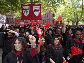 File - Graduating Harvard University students celebrate their degrees during commencement ceremonies, on May 25, 2023 in Cambridge, Mass. Student loan payments resume in October after a three-year pause due to the pandemic.