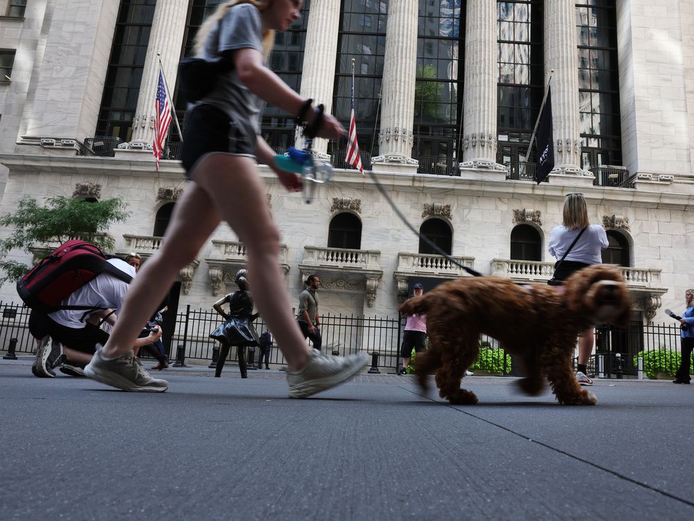 People walk by the New York Stock Exchange.