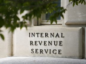FILE - A sign outside the Internal Revenue Service building is seen, May 4, 2021, in Washington. The IRS is pausing accepting claims for the Employee Retention Credit, a pandemic-era tax credit, until 2024 due to rising concerns that an influx of applications are fraudulent. The IRS said Thursday, Sept. 14, 2023, that hundreds of criminal cases have been started and thousands of ERC claims have been referred for audit.