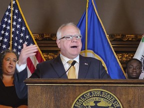 FILE - Minnesota's Democratic Gov. Tim Walz speaks during a news conference at the state Capitol, Aug. 16, 2023, in St. Paul, Minn. People living in Minnesota without legal immigration status can now begin the process of getting their driver's license by making an appointment for their written driver's test, state officials announced at a news conference Thursday, Sept. 7. Walz signed the measure into law this year.