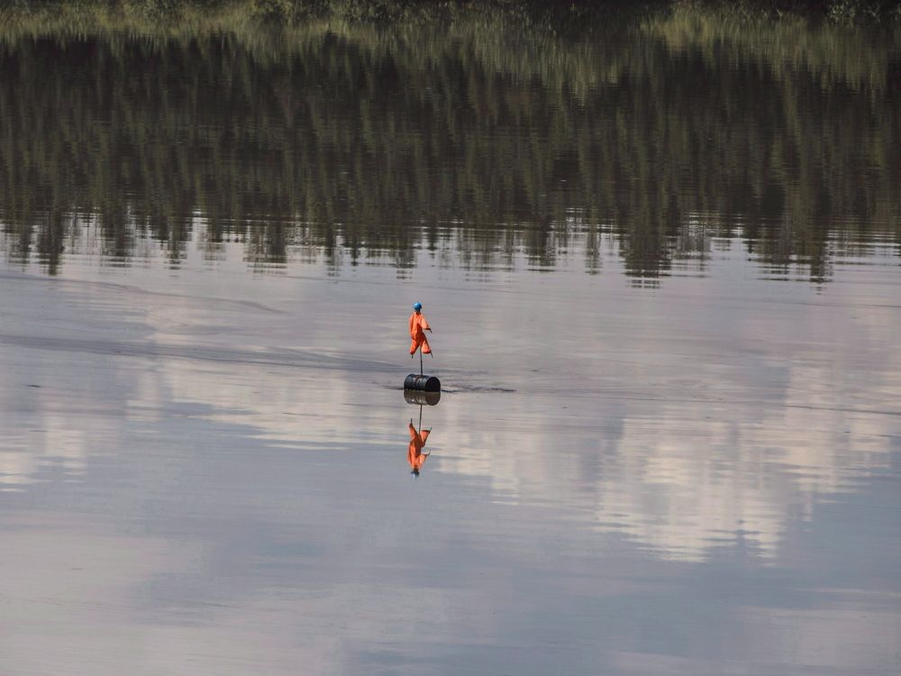 A scarecrow floats in an oilsands tailings pond in Alberta. The International Energy Agency says no new major oil and gas extraction projects, nor new coal mines, are needed anywhere around the globe.