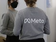 Company representatives wear branded Meta t-shirts.