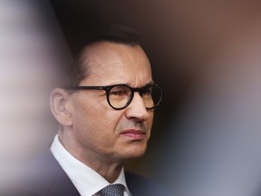 FILE - Poland's Prime Minister Mateusz Morawiecki talks to journalists as he arrives for the third EU-CELAC summit in Brussels, Belgium, Tuesday, July 18, 2023. Polish and U.S. officials signed an agreement Wednesday, Sept. 27, 2023 in Warsaw for the construction of Poland's first nuclear power plant, part of an effort by the Central European nation to move away from polluting fossil fuels.
