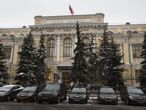 FILE - Cars are parked in front of Russia's Central Bank building in Moscow, Russia, Friday, Jan. 30, 2015. The Central Bank of Russia raised its key lending rate by one percentage point to 13% on Friday, Sept. 15, 2023, a month after imposing an even larger hike, as concerns about inflation persist and the ruble continues to struggle against the dollar.