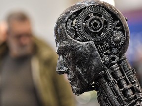 A global group of 25 organizations including news and publishing companies is calling on developers, operators and deployers of artificial intelligence systems to respect intellectual property rights. A metal head made of motor parts symbolizes artificial intelligence, or AI, at the Essen Motor Show for tuning and motorsports in Essen, Germany on Nov. 29, 2019, file photo.