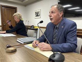 North Dakota Public Service Commission Chairman Randy Christmann, right, begins a meeting of the commission at the state Capitol in Bismarck, N.D., Friday, Sept. 15, 2023. At left is Commissioner Sheri Haugen-Hoffart. The panel, in a 2-1 vote, approved a request by Summit Carbon Solutions to reconsider the commission's Aug. 4 decision to deny a siting permit for the company's proposed 320-mile route in North Dakota. The leg is part of Summit's proposed $5.5 billion, 2,000-mile, five-state pipeline network to carry planet-warming carbon dioxide emissions from 30-some Midwestern ethanol plants to central North Dakota for permanent storage deep underground.