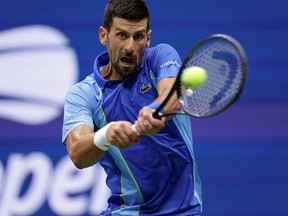 Serbia's Novak Djokovic returns the ball during the U.S. Open tennis tournament in New York. Tennis offers many apt comparisons to investing, writes Howard Marks.