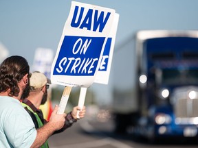 UAW members strike outside the General Motors plant in Wentzville, Missouri on Sept. 15. For the first time in its history the United Auto Workers union is on strike against all three of America’s unionized automakers, General Motors, Ford and Stellantis, at the same time.