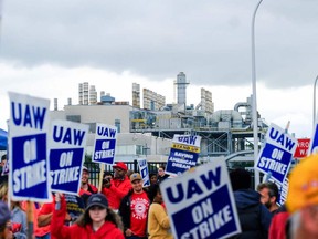 Members of the United Auto Workers (UAW) picket outside the Michigan Parts Assembly Plant on Sept. 26.