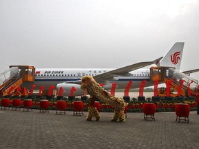 Dancers perform a lion dance near the 100th A320 airplane assembled at the Tianjin plant of Airbus in north China's Tianjin Municipality on Aug. 31, 2012. Multiple passengers were injured after an engine fire sent smoke into the cabin of Air China's Airbus A320 jetliner, the same model seen in this photo, that was landing in Singapore, prompting an evacuation of the aircraft Sunday, Sept. 10, 2023. Changi Airport said in a statement on its Facebook page. The flight was coming from the city of Chengdu in China's Sichuan province. (Chinatopix Via AP)