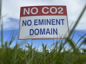 A sign reading "No CO2, no eminent domain" stands along a rural road east of Bismarck, N.D., on Tuesday, Aug. 15, 2023. The sign is in opposition to Summit Carbon Solutions' proposed $5.5 billion, 2,000-mile pipeline network to carry carbon dioxide emissions from dozens of ethanol plants in five states to central North Dakota for permanent storage deep underground.