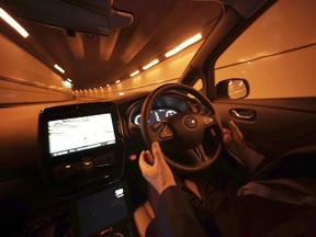 Experts warn modern, connected vehicles, which are heavily packed with microchips and sophisticated software, offer an open door to hackers. Nissan Motor Co. General Manager Tetsuya Iijima gets his hands off of the steering wheel of a self-driving prototype vehicle during a test drive in Tokyo, Tuesday, Nov. 3, 2015.