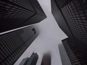 The Canadian flag blows in the wind in the heart of the financial district in Toronto on June 27, 2018.&ampnbsp;Canada's banking regulator has released draft guidelines on how it expects to oversee areas of risks that go beyond the financial health of institutions.