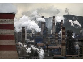 HEBEI, CHINA -JUNE 2: Smoke and steam billows from a Chinese state owned steel plant on June 2, 2017 in Hebei, China. China, the world's largest polluter, reaffirmed its commitment to the Paris Climate Accord Friday, after US President Donald Trump announced his intentions to withdraw the United States from the agreement on Thursday.