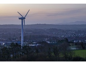A wind turbine stands overlooking Andersonstown, Belfast, Northern Ireland, U.K., on Friday, Jan. 3, 2020. With the U.K. due to leave the European Union, questions remain over trading agreements and Ireland's 12-year-old single electricity market, known as the SEM. Photographer: Hollie Adams/Bloomberg