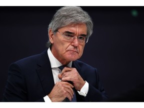 Joe Kaeser, former chief executive officer of Siemens AG, adjusts his tie during the company's full year earnings news conference in Munich, Germany, on Wednesday, Feb. 3, 2021. Siemens AG raised its annual guidance after better-than-expected sales and profit in the first quarter, the latest sign Europe's biggest engineering company is benefiting from a strong rebound in China.