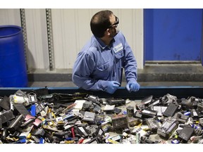 A worker sorts batteries at the Li-Cycle lithium-ion battery recycling facility in Kingston, Ontario.