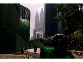 A near-empty street near the Petronas Twin Towers during a Movement Control Order (MCO) in Kuala Lumpur, Malaysia, on Wednesday, Aug. 11, 2021. Malaysia has eased virus restrictions for those who have completed the full vaccination regime, allowing them to cross state borders and dine at restaurants as authorities seek to re-open the economy. Photographer: Samsul Said/Bloomberg