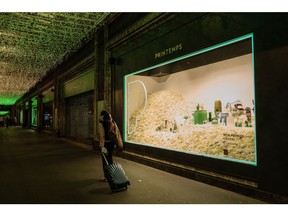A pedestrian passes a window display of the Printemps department store in the Opera district of Paris, France, on Thursday, April 7, 2022. The cost of living is a major issue in the French presidential election, with recent polls showing incumbent Emmanuel Macron's lead over far-right candidate Marine Le Pen narrowing ahead of Sunday's first-round vote.